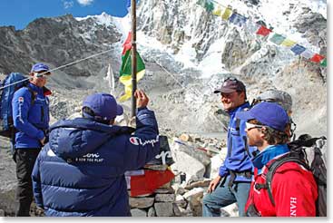 Before the climbers take off, Ang Tshering throws rice three times as a blessing for the climbers