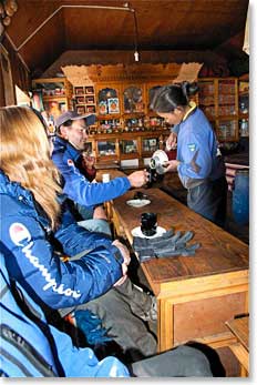 Kami Tshering Sherpa's daughter serves Jamie tea in Kami's home in Pangboche.