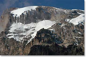 Between Lava Tower Camp and Karanga Camp, the trail traverses beneath Kili’s spectacular Breach Wall.