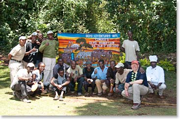 The group gathers for a photo with Dave and his banner.