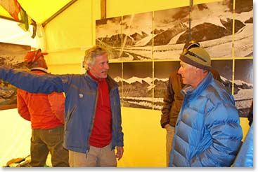 David describes the work to one of the expedition leaders in front of historical and current photos of Rongbuk Glacier in the north side of Everest.