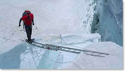 Crossing a deep crevasse below Camp III.