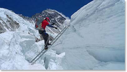 Jamie tackles another ladder with Everest watching in the background.