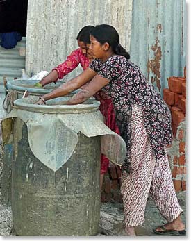 Women mixing concrete by hand in Boudhanath