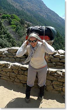 Maya trying on the porter's load: her personal trainer back home will be happy to see her continuing with her training regimen!