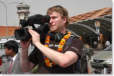 Kenny Wilson behind the camera as the rest of the team arrives at the airport in Kathmandu.