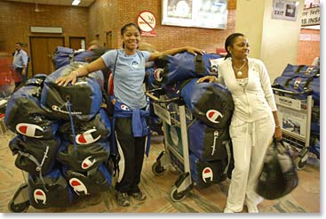 LaQuishia and her mother, LaShonda, navigate their bags through the airport.