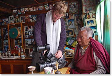 After receiving his kata, Kenny shows Lama Geshe how to run the camera.