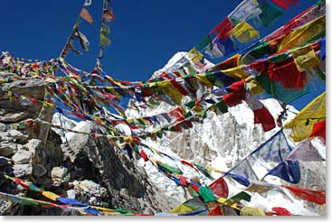 Prayer flags wave in the wind on the summit of Kala Patar.