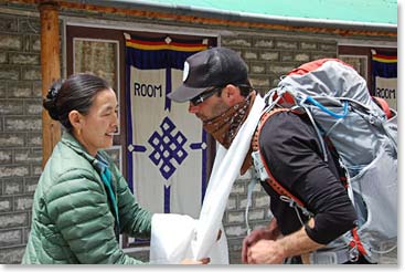 Yangzing bids farewell to Adam with a kata scarf, a blessing for good luck.