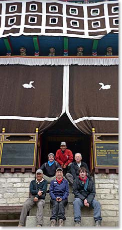 The team sits in front of the Tengboche monastery.