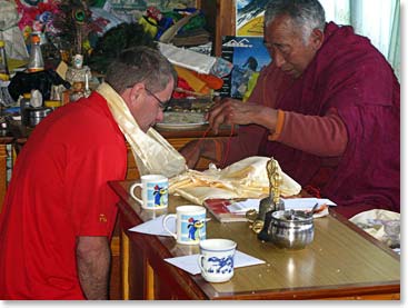 Trevor receives his blessing from Lama Geshe.
