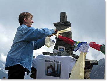 Brenda tied a special kata, blessed by Lama Geshe, to the memorial.