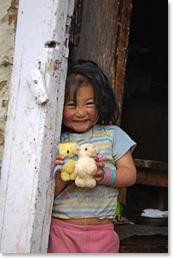 A local girl checks us out from her doorway as we leave Pheriche.
