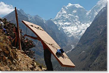 Sherpas are carrying building supplies past us up the trail where they are building a new lodge.