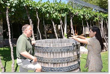 Mariela explaining a wine press to Stuart