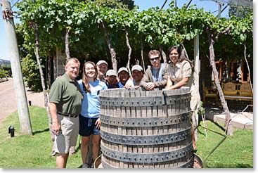 The group poses with the wine press