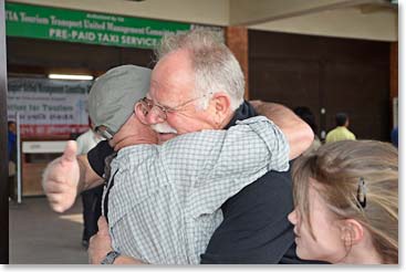 Old friends Wally and Woodie reunite in an embrace as Woodie’s granddaughter Mathes looks on.