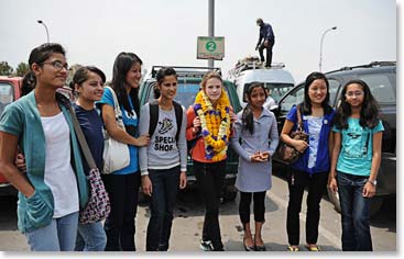 Rupa arranged for a group of girls to greet Mathes at the airport and each of them gave her a garland.