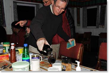 Paul pouring wine before dinner. The decades old Pocket Book of Verse in his hand.