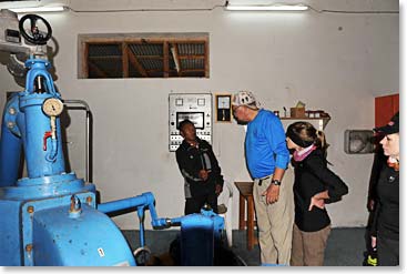 Woodie and Mathes listen as Mingma Rita explains the operation inside the powerhouse.