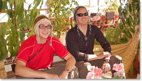 The brothers sit on a sofa made of reeds.