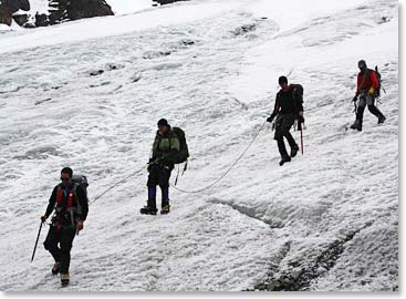 The team reaches the lower glacier where they take off their crampons and hike back to bc.