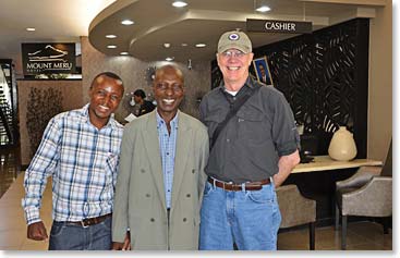 BAI Guides, Eric Marimbo, Julius Minja, Bob Birkby in lobby of Mt Meru Hotel.