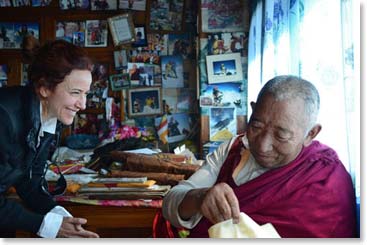Raquel is beaming with joy as Lama Geshi prepares to bless her.
