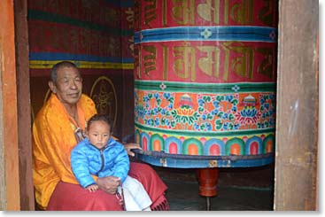 There are prayer wheels all along the trail, big ones and small ones. They all spin; here a lama holds a small child as he sends the prayer wheel on endless clockwise cycles.