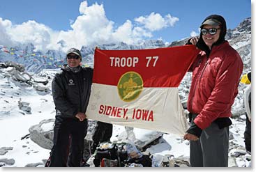 Wally and Bob Birkby at Base Camp with a historic flag: troop Boy Scout 77 from Sydney Iowa.