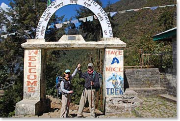 Bob and Jennie give a celebratory high five as they arrive at the top of the hill in Lukla.