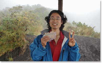 Yuki having lunch at the viewpoint, protected from the elements
