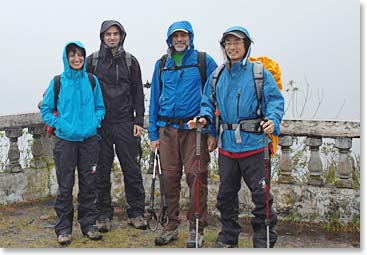Team by the lake in the rain