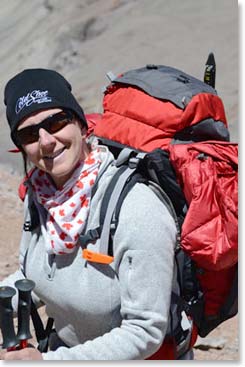 Linda smiling as she climbs higher.