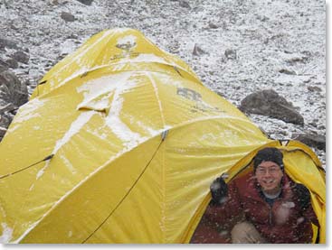 Winston peeks out into the snow from his cozy North Face tent.