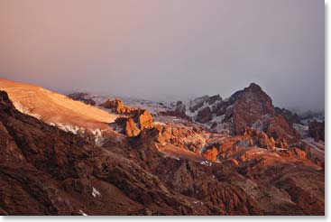 Fading light catches the craggy mountain above us.