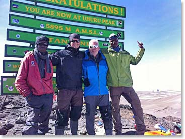 Tim and Rafael pose on the summit with Julius and Emmanuel