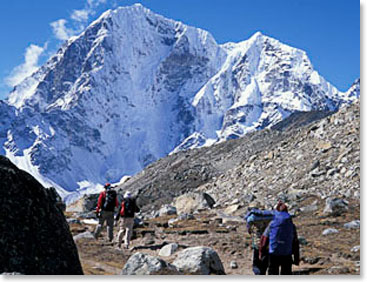 Cholotse Peak towers above trekkers on the way to the village of Lobouche