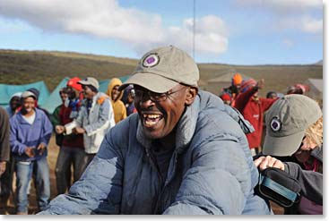 BAI chief guide, John,  celebrating our arrival at Shira and inviting everyone to dance