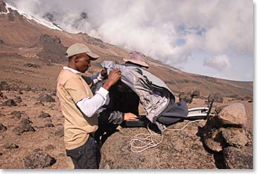Working on his Toughbook laptop on the mountain