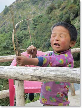 This young man was enjoying playing with his homemade bow and arrow.