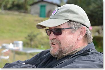 Our lodge was along the side of the airstrip. Gerry took a seat to watch the aircraft coming and going.