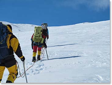 Climbers balancing the fixed line using their ascenders and ice axe