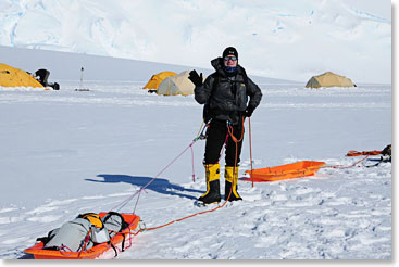 A climber hooked up to his sled, making it effortless to move his gear around.