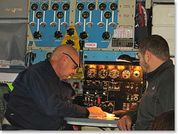 The Russian flight engineers work with their analog computers on our flight south.