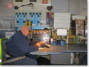 The Russian flight engineers work with their analog computers on our flight south.