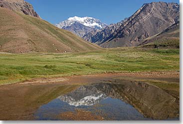 Beautiful reflection of Aconcagua on the little lake by the welcome sign