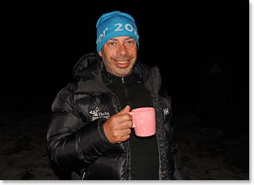 Neil enjoying a hot drink on one of his previous climbs