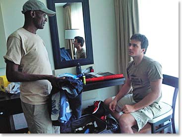 John helping Roberto sort his gear and pack for the climb